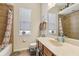 Bright bathroom with a granite countertop, a soaking tub, and a window for natural light at 14494 Copeland Way, Brooksville, FL 34604