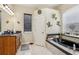 Bathroom featuring a vanity, soaking tub, and large window at 14494 Copeland Way, Brooksville, FL 34604