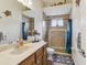 Charming bathroom featuring a granite countertop, decorative fish, and walk-in shower at 14494 Copeland Way, Brooksville, FL 34604