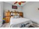 Comfortable bedroom featuring a charming bed frame and a decorative ceiling fan at 14494 Copeland Way, Brooksville, FL 34604