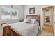 Comfortable bedroom features a classic wood bedframe and a bright window at 14494 Copeland Way, Brooksville, FL 34604