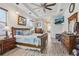 Primary bedroom with hardwood floors, tray ceiling, and ensuite bathroom at 14494 Copeland Way, Brooksville, FL 34604
