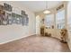 Spacious dining area with tile flooring, modern lighting, and a wine rack near the window at 14494 Copeland Way, Brooksville, FL 34604