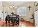 Dining room with hardwood floors, modern chandelier, and large window at 14494 Copeland Way, Brooksville, FL 34604