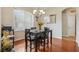 Inviting dining room featuring wood floors, a modern chandelier, and large window views at 14494 Copeland Way, Brooksville, FL 34604