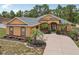Inviting single-story home with a well-manicured front yard, mature palms and decorative landscaping at 14494 Copeland Way, Brooksville, FL 34604