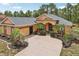 Inviting single-story home with a well-manicured front yard, mature palms, attached garage and decorative landscaping at 14494 Copeland Way, Brooksville, FL 34604