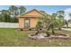 Beautifully landscaped front yard with decorative brick border, flower pots and yard decor at 14494 Copeland Way, Brooksville, FL 34604