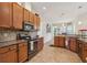Well-lit kitchen with granite countertops, stainless steel appliances, and ample cabinet space at 14494 Copeland Way, Brooksville, FL 34604