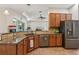 Open kitchen featuring stainless steel appliances, granite countertops, and backyard views at 14494 Copeland Way, Brooksville, FL 34604