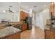 Bright, open kitchen with stainless steel appliances, granite countertops, and a seamless flow to other rooms at 14494 Copeland Way, Brooksville, FL 34604