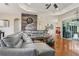 Bright and airy living room featuring wood floors, comfortable seating, and a stylish accent wall at 14494 Copeland Way, Brooksville, FL 34604