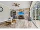 Spacious living room featuring a large window, fireplace, and ample seating at 14494 Copeland Way, Brooksville, FL 34604