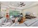 Spacious living room with wood floors, comfortable seating, and access to outdoor screened patio at 14494 Copeland Way, Brooksville, FL 34604