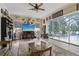 Open living room featuring bright windows and access to the pool area at 14494 Copeland Way, Brooksville, FL 34604