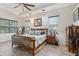 The bedroom features a wood bed, wood floor, and a ceiling fan at 14494 Copeland Way, Brooksville, FL 34604