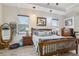 Bright and airy bedroom with wood flooring, a large bed, and tasteful decor at 14494 Copeland Way, Brooksville, FL 34604