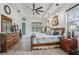 Spacious main bedroom with wood-look flooring, tray ceiling, and stylish furnishings at 14494 Copeland Way, Brooksville, FL 34604