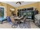 Outdoor patio featuring dining table and seating, with a view of the screened-in pool at 14494 Copeland Way, Brooksville, FL 34604