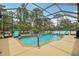 Beautiful screened pool and patio area with lush landscaping, perfect for outdoor enjoyment at 14494 Copeland Way, Brooksville, FL 34604