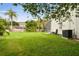 Expansive backyard with lush green lawn and a screened-in patio perfect for outdoor relaxation at 16003 Ridley Pl, Tampa, FL 33647