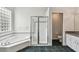 Spacious bathroom with double sink vanity, glass block window, large tub and glass shower at 16003 Ridley Pl, Tampa, FL 33647