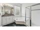 Bathroom featuring a garden tub, glass block window and a separate shower for a spa-like experience at 16003 Ridley Pl, Tampa, FL 33647
