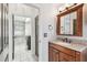 Bathroom with a vanity, mirror and view into the adjacent laundry room at 16003 Ridley Pl, Tampa, FL 33647