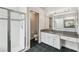 Bathroom with shower and vanity area featuring solid surface counters and black tile floors at 16003 Ridley Pl, Tampa, FL 33647