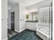 Spacious bathroom with double sink vanity, glass block window, large tub and glass shower at 16003 Ridley Pl, Tampa, FL 33647