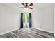 Cozy bedroom features neutral paint, stylish ceiling fan and grey wood-look flooring at 16003 Ridley Pl, Tampa, FL 33647