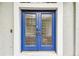 Elegant blue double front door with glass detailing, set in a bright, welcoming entryway at 16003 Ridley Pl, Tampa, FL 33647