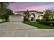 Charming two-story home with a well-manicured lawn, arched entry, and a two-car garage at 16003 Ridley Pl, Tampa, FL 33647