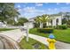Charming two-story home with a well-manicured lawn, lush landscaping, and a convenient mailbox on a sunny day at 16003 Ridley Pl, Tampa, FL 33647