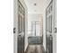 Hallway showing the doors and flooring leading to the primary bathroom at 16003 Ridley Pl, Tampa, FL 33647