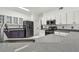 Kitchen featuring sleek black appliances, gray countertops, and white cabinets for a modern look at 16003 Ridley Pl, Tampa, FL 33647