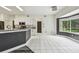 Bright kitchen features white cabinetry, modern appliances, and grey countertops with white tile flooring at 16003 Ridley Pl, Tampa, FL 33647