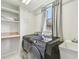 Bright laundry room with modern washer and dryer, utility sink, built-in shelving, and a window at 16003 Ridley Pl, Tampa, FL 33647