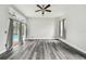 Spacious living room with modern floors, curtains, and sliding doors overlooking a pool at 16003 Ridley Pl, Tampa, FL 33647
