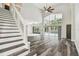 Bright living room with soaring ceilings features a staircase, large windows, and pool view at 16003 Ridley Pl, Tampa, FL 33647