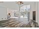 Spacious living room with luxury vinyl flooring, large windows, and vaulted ceilings at 16003 Ridley Pl, Tampa, FL 33647