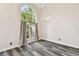Elegant living room features wood floors, a chandelier, and a large arched window with lush views at 16003 Ridley Pl, Tampa, FL 33647