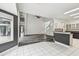 Open-concept living space with tiled floors transitions to wood-look floors and kitchen at 16003 Ridley Pl, Tampa, FL 33647