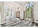 Elegant living room features soaring ceilings, chandeliers, and large windows with lush views at 16003 Ridley Pl, Tampa, FL 33647