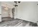Open-concept living room featuring gray wood floors, chandelier, and large white support columns and trim at 16003 Ridley Pl, Tampa, FL 33647
