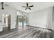 Spacious living area boasting wood-look floors and direct access to the screened-in patio and pool area at 16003 Ridley Pl, Tampa, FL 33647