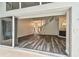 Open-concept living room with gray wood floors and large glass doors for lots of light at 16003 Ridley Pl, Tampa, FL 33647