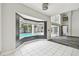 Bright living room boasts a bay window with a view of the sparkling pool at 16003 Ridley Pl, Tampa, FL 33647