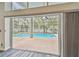 View of a screened in pool area from inside home at 16003 Ridley Pl, Tampa, FL 33647