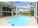 Exterior view of the screened-in pool area and home at 16003 Ridley Pl, Tampa, FL 33647